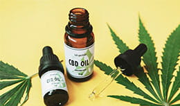 image of small bottle of cbd oil and droplet 