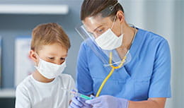 image of children getting vaccinated with a mask on