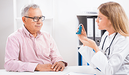 Doctor talking to a patient with an inhaler