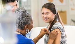 Teenage girl getting a vaccine in an office