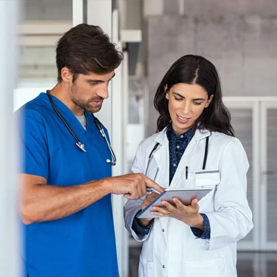 Doctor and Nurse review computer tablet