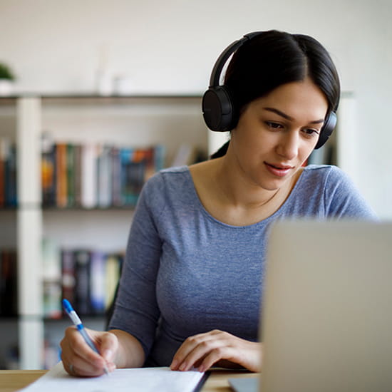 Woman watching class on laptop computer