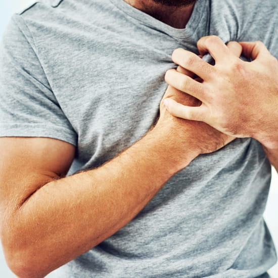 man clutching chest