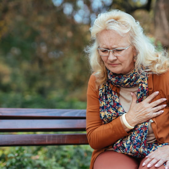 Older woman holding chest