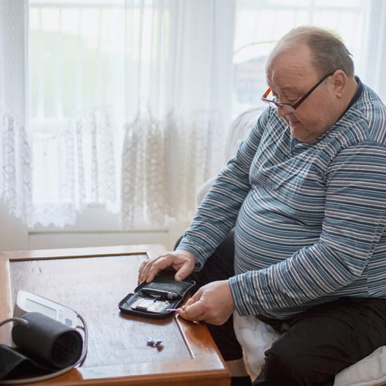 Diabetic man checking blood glucose