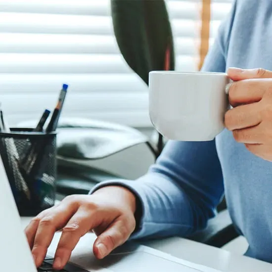 Man on computer with coffee