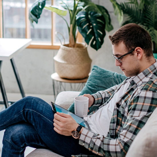 Man reading on computer tablet