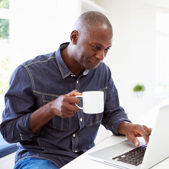 African-American man using laptop computer