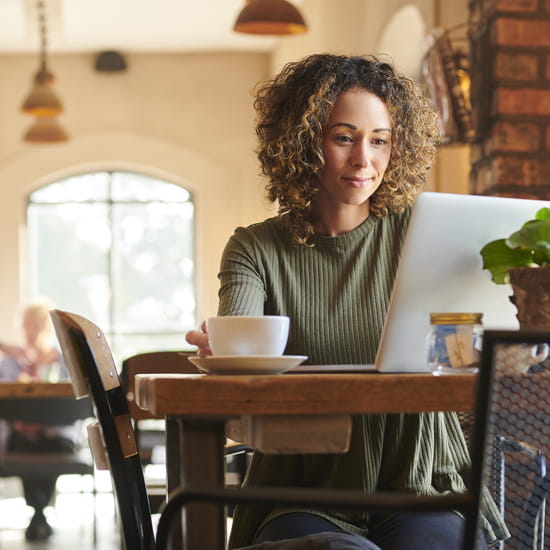 Woman in cafe on laptop computer