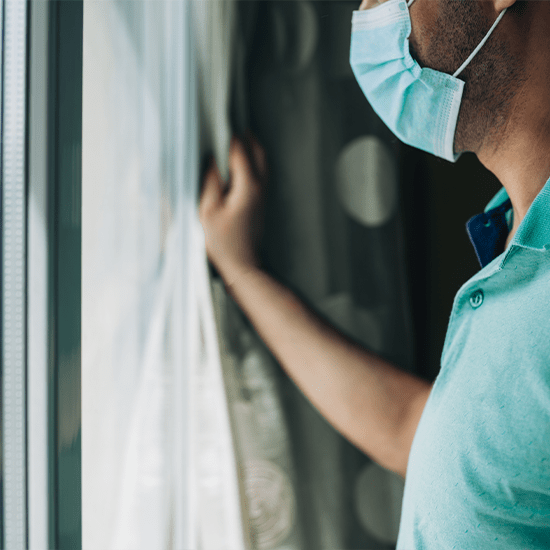 looking outside through glass with mask indoors
