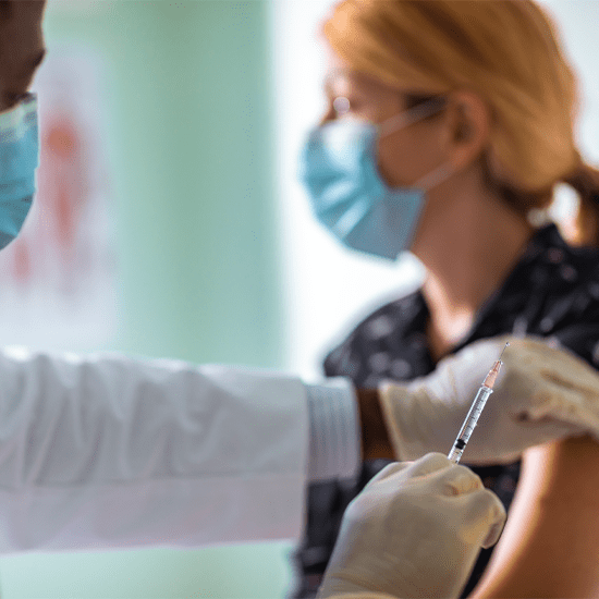 doctor administering vaccine