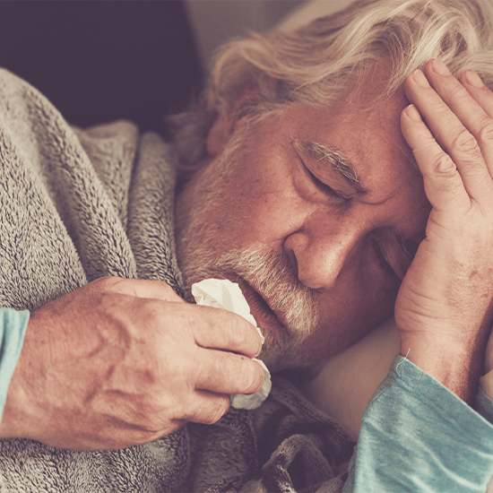 older man in bed with flu