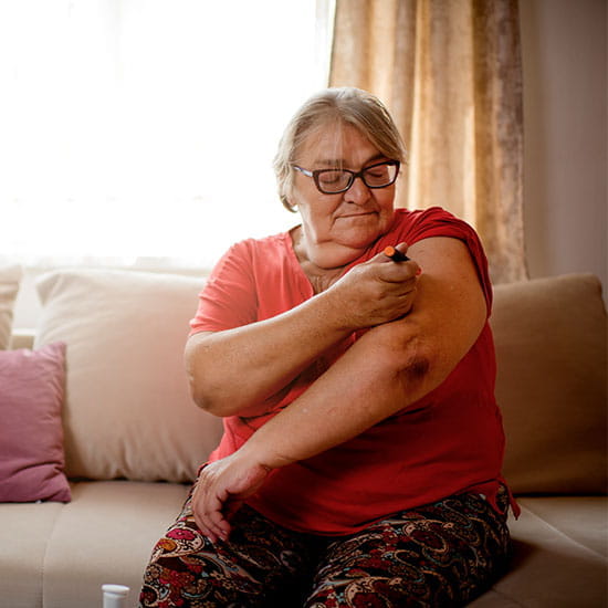 Senior woman injecting insulin