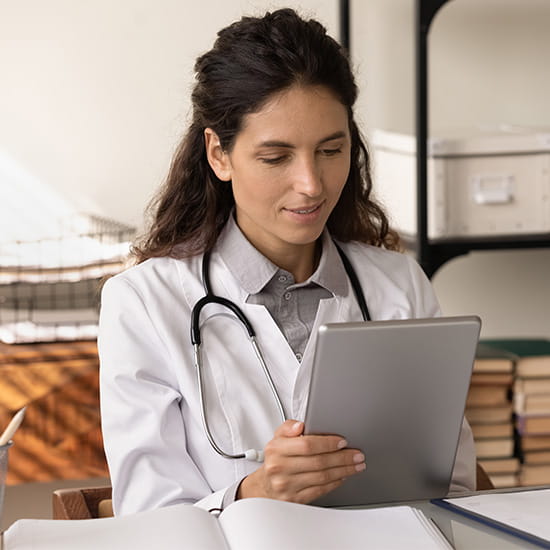 female doctor reading on her ipad 