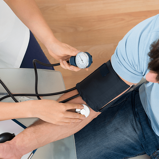 doctor reading blood pressure of patient