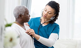 Female home healthcare providers checks patient's vital signs