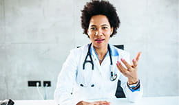 Portrait of a female doctor talking at camera