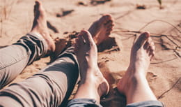 Set of feet closeup on the beach