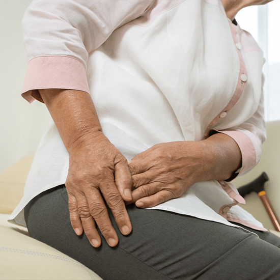 woman grabbing at hip in pain