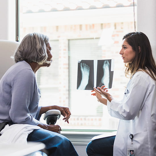 doctor showing patient foot x-ray
