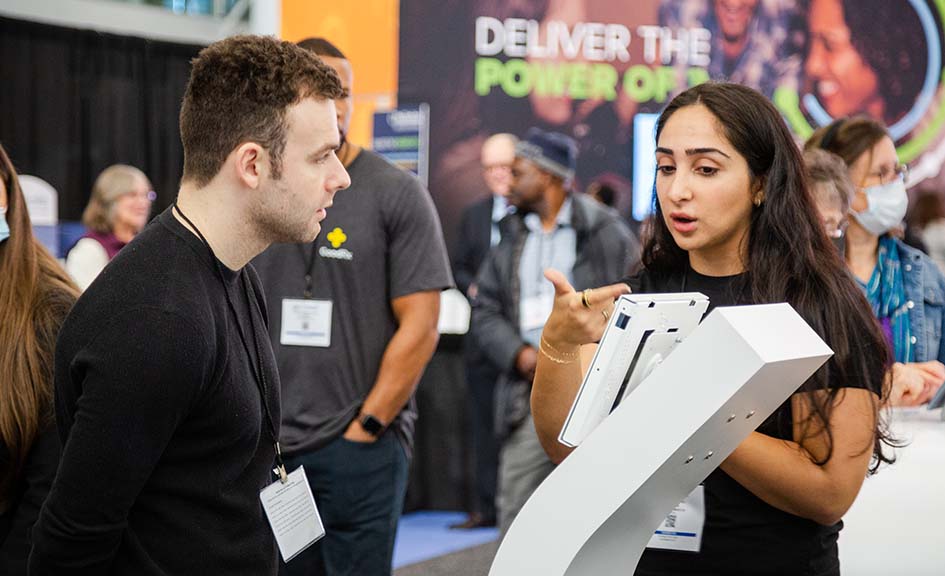 man and woman speaking in exhibit hall