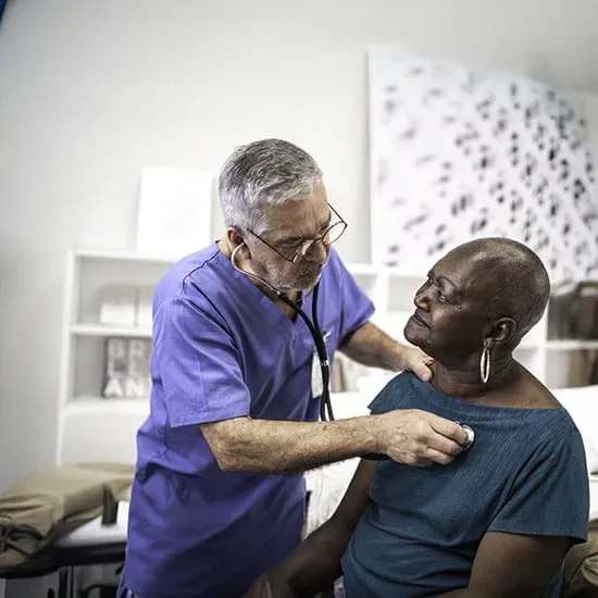 Doctor using a stethoscope listen to the heartbeat of a patient