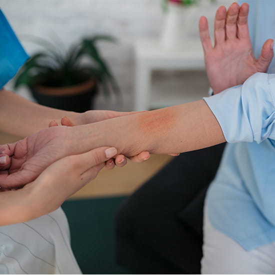 Physician checking out patients arm with skin discomfort
