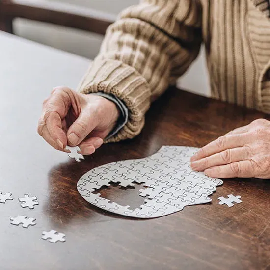 Cropped view of senior man playing with puzzles