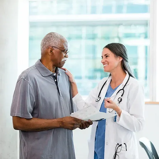 Doctor talking to elderly male patient
