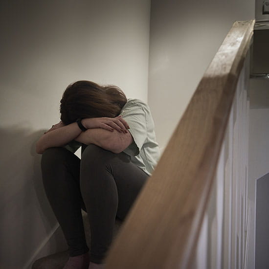 Woman crying on stairs