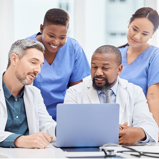 Group of doctors looking at a computer