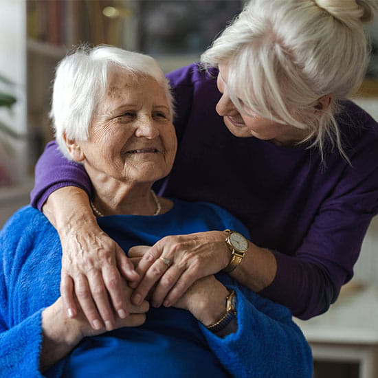 Women hugging her elderly mother