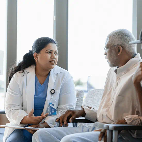 doctor speaking to elderly patient 
