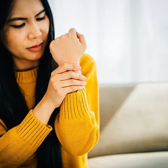Woman holding her wrist