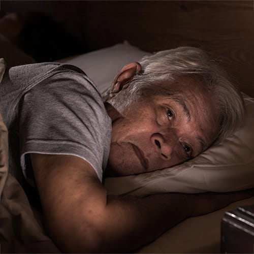 Man lying in bed at night