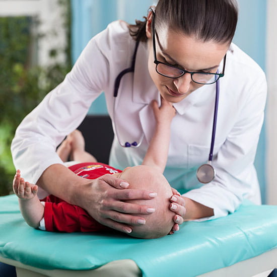 doctor assessing baby on table