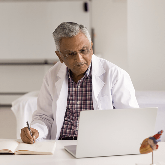 doctor going over chart on laptop