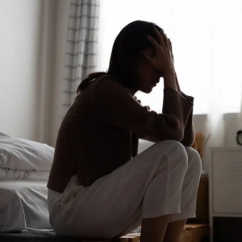 Woman with hands on her forehead