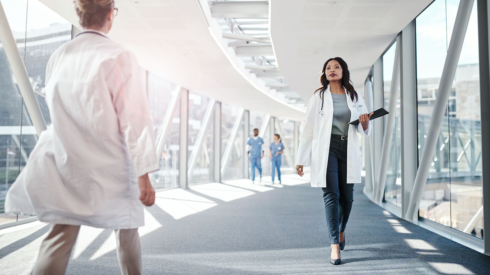 Doctors walking across medical bridge
