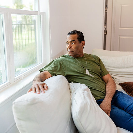 Veteran sitting in a wheelchair speaking to a doctor