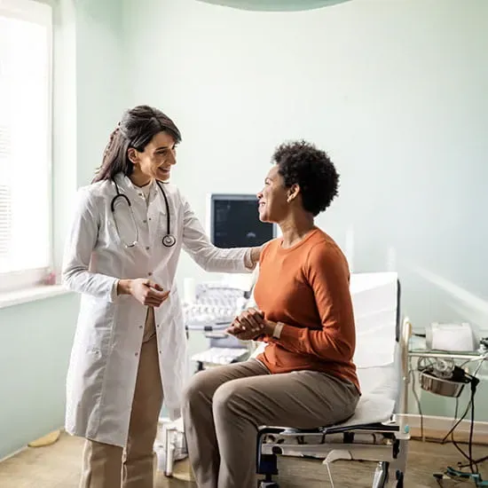 Doctor taking notes while listening to a patient