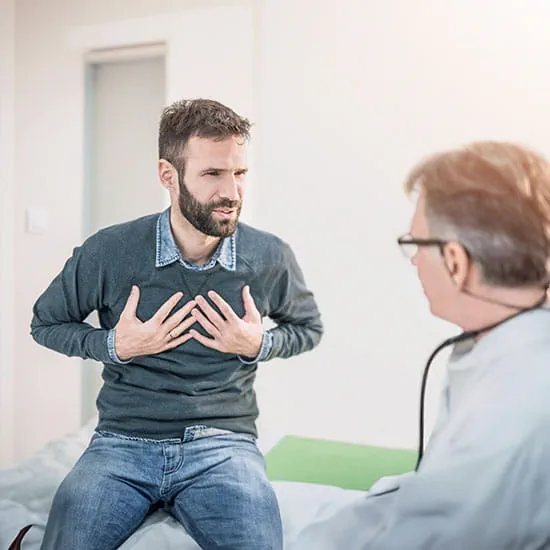 Male patient describing a chest pain to his doctor