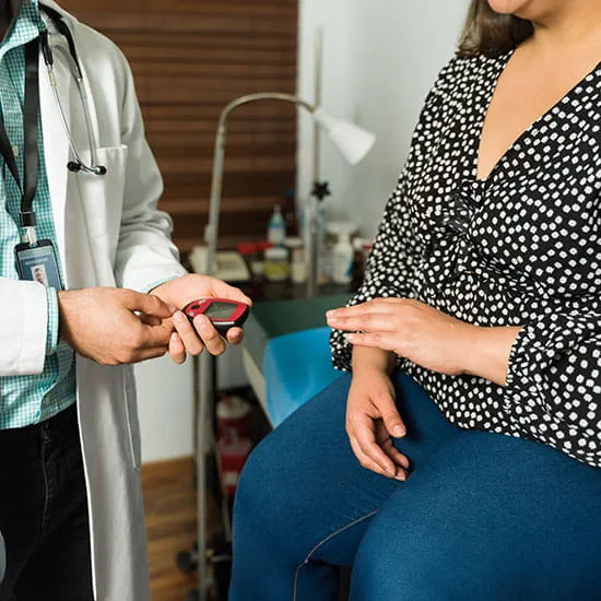Physician using a blood glucose monitor
