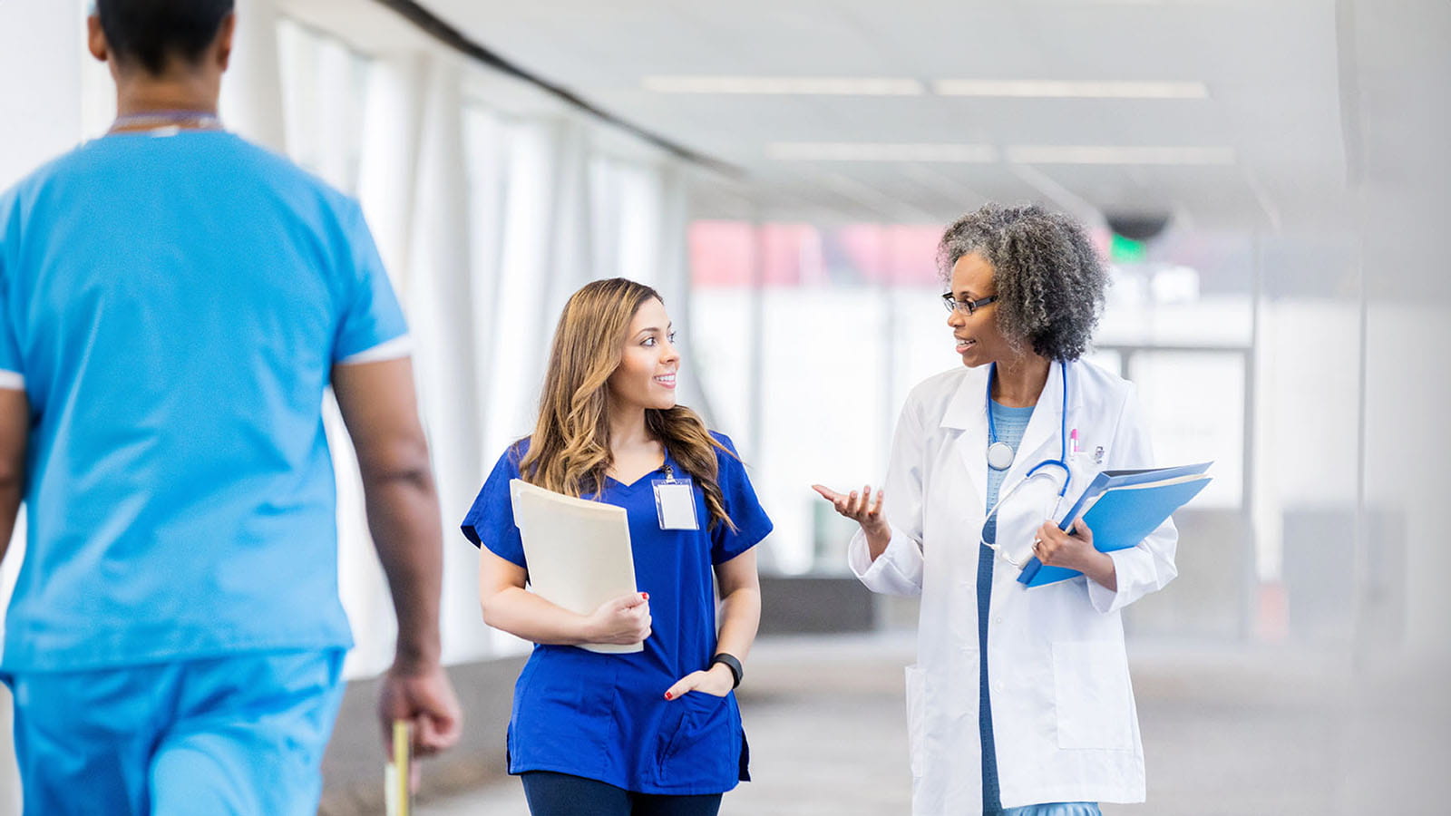 Medical staff walking down hospital hallway