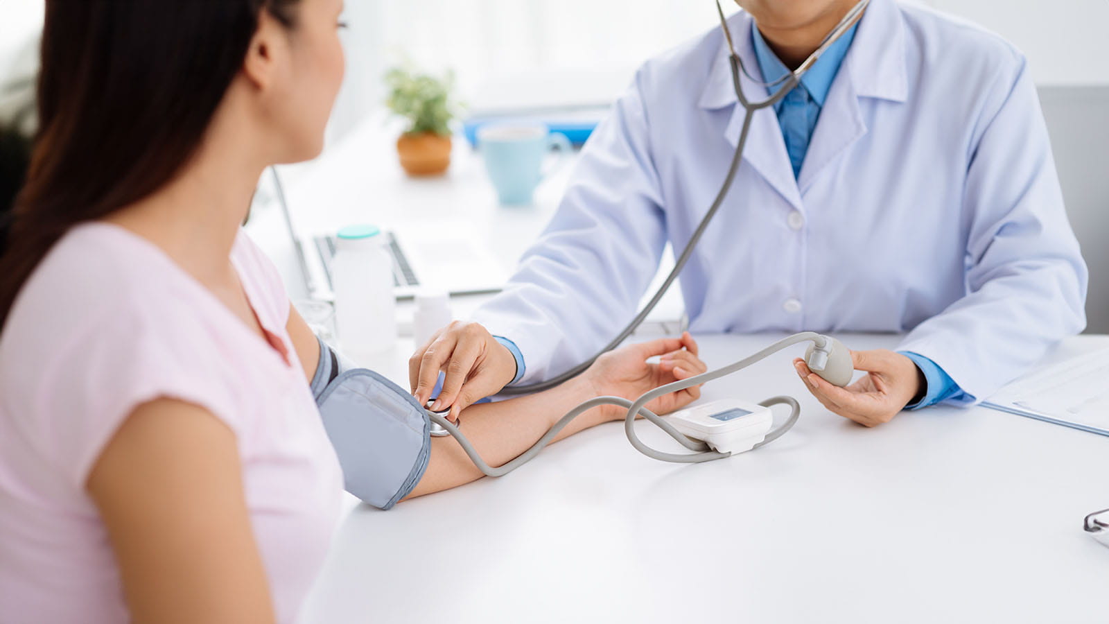Doctor listening to patients pulse