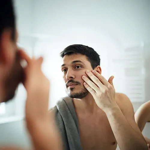 Man applying lotion to face