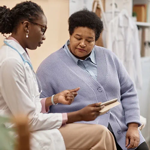 Doctor showing a patient a tablet