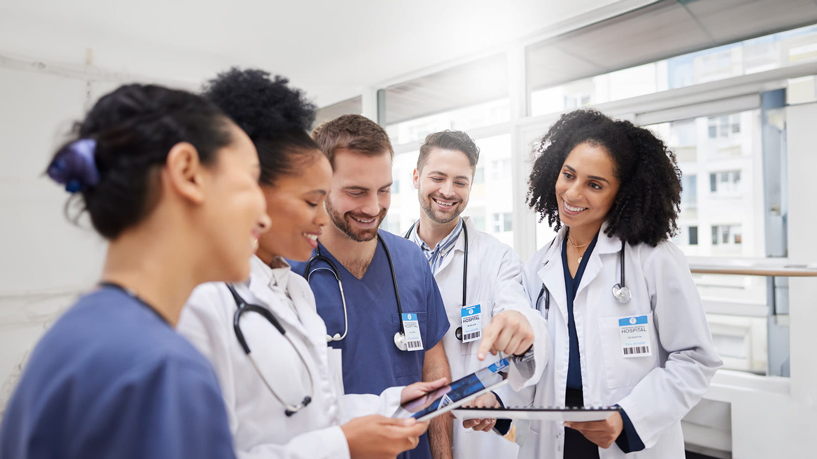 A group of doctors looking at a tablet