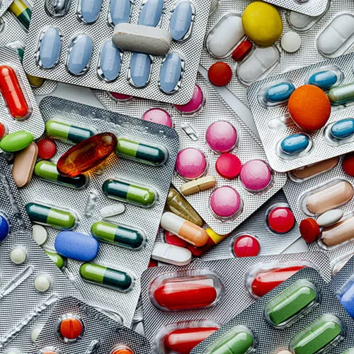 Background of a large group of assorted capsules and pills