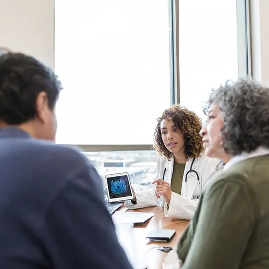 Neurologist discusses brain scan with patient